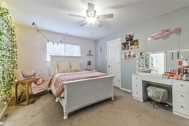 bedroom with light carpet and a ceiling fan