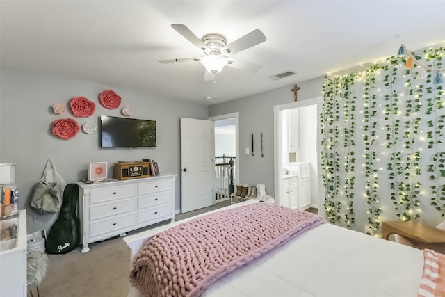 carpeted bedroom with ensuite bath, a ceiling fan, and visible vents