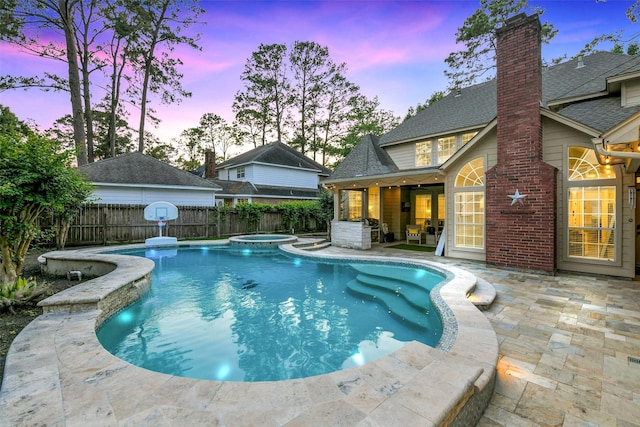 view of swimming pool with a fenced backyard, a patio area, and a pool with connected hot tub