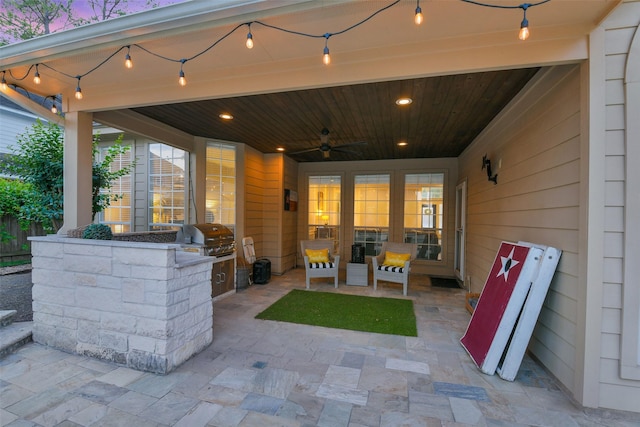 view of patio / terrace with ceiling fan, area for grilling, and a grill