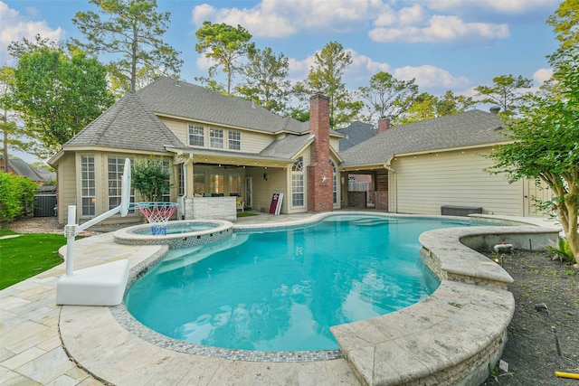 view of swimming pool with a patio and a pool with connected hot tub