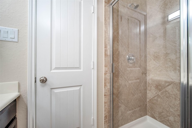 bathroom with vanity and a shower stall
