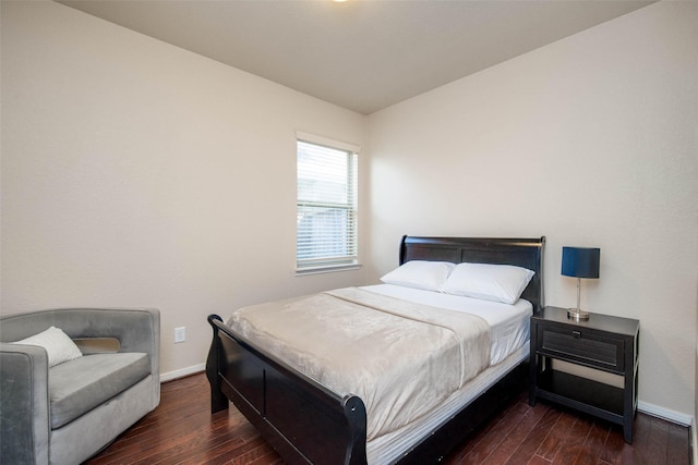bedroom with wood finished floors and baseboards