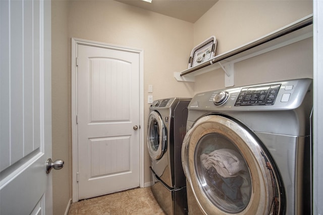 washroom featuring washing machine and dryer and laundry area