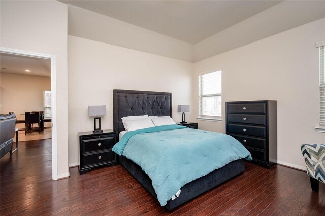 bedroom featuring dark wood-type flooring and baseboards