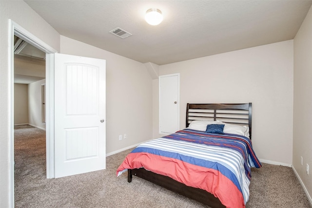 carpeted bedroom with visible vents and baseboards
