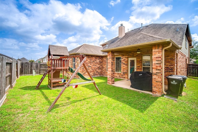 back of property featuring a fenced backyard, a patio area, brick siding, and a playground