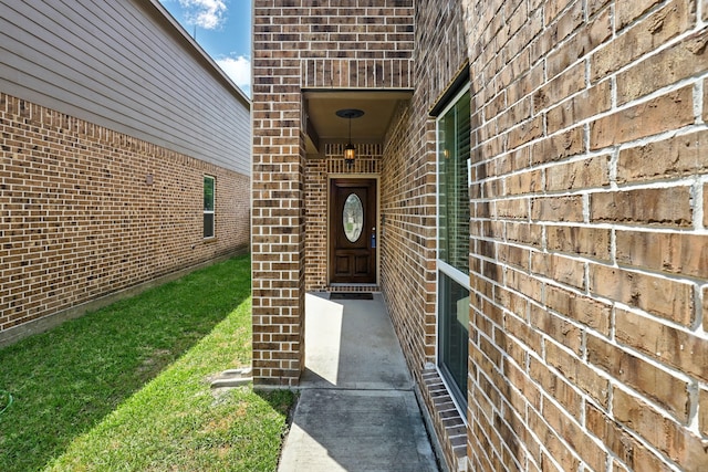 doorway to property featuring brick siding