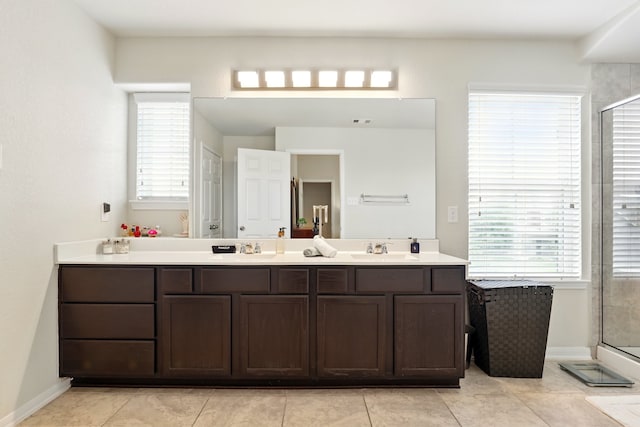 bathroom featuring a shower stall, a wealth of natural light, and a sink