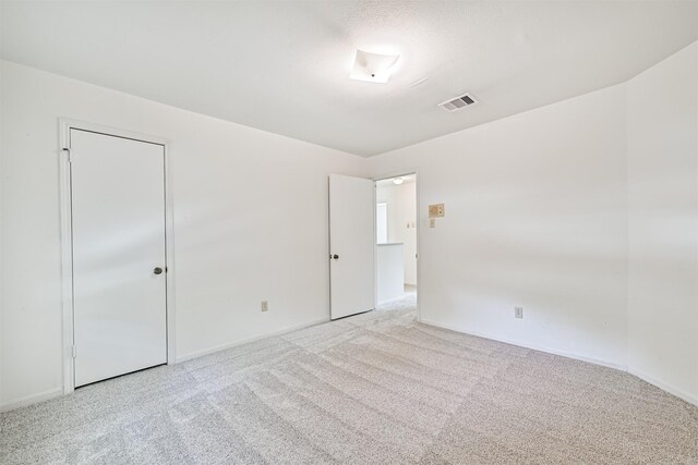 unfurnished bedroom featuring carpet floors, baseboards, and visible vents
