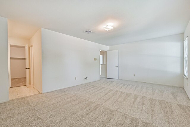 unfurnished room with carpet floors, baseboards, and visible vents