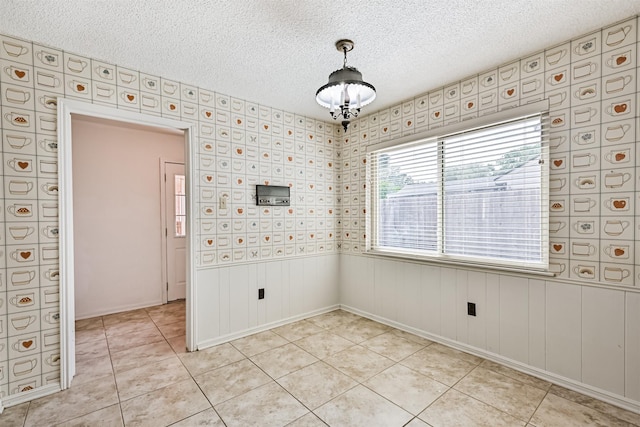 4206 Willow Hill Dr, Seabrook, TX 77586 - unfurnished room with light tile patterned floors, wainscoting, and a textured ceiling