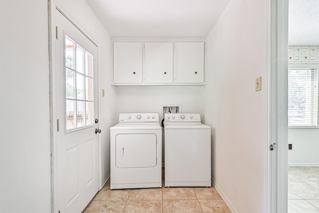 4206 Willow Hill Dr, Seabrook, TX 77586 - clothes washing area featuring washer and dryer, baseboards, light tile patterned floors, and cabinet space
