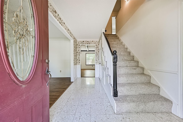 4206 Willow Hill Dr, Seabrook, TX 77586 - entryway featuring a decorative wall, ornamental molding, wainscoting, and stairs