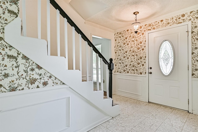4206 Willow Hill Dr, Seabrook, TX 77586 - foyer featuring stairway, a wainscoted wall, ornamental molding, and a wealth of natural light