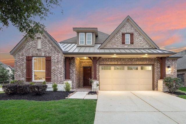 craftsman house featuring a standing seam roof, driveway, brick siding, and metal roof
