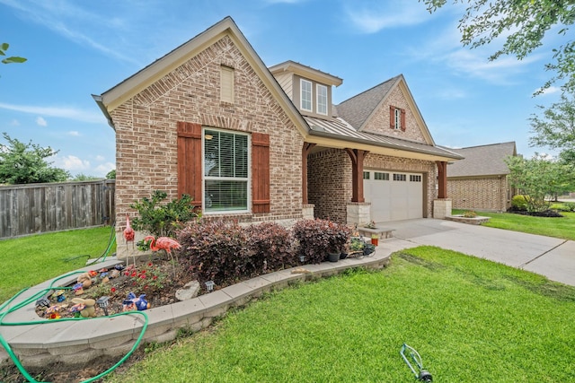 view of front of home with a front lawn, driveway, fence, brick siding, and an attached garage