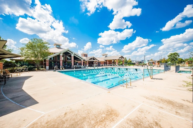 pool featuring fence and a patio