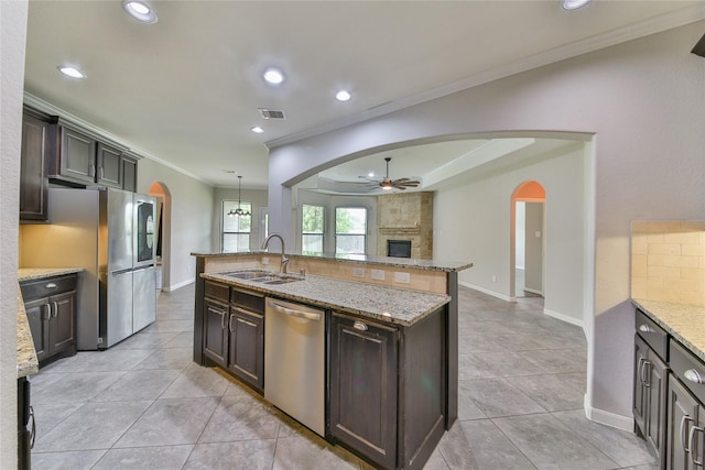 kitchen with a ceiling fan, crown molding, a sink, stainless steel appliances, and visible vents