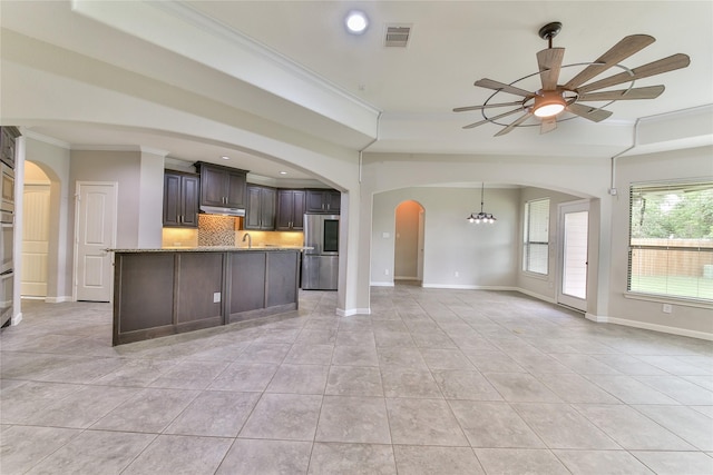 kitchen with stainless steel appliances, open floor plan, visible vents, ceiling fan with notable chandelier, and crown molding