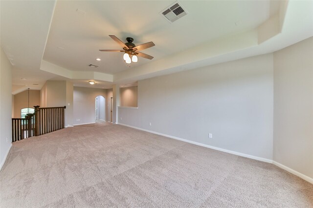 carpeted spare room with baseboards, visible vents, recessed lighting, a ceiling fan, and a raised ceiling