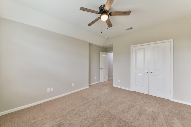 unfurnished bedroom with visible vents, a ceiling fan, light carpet, a closet, and baseboards