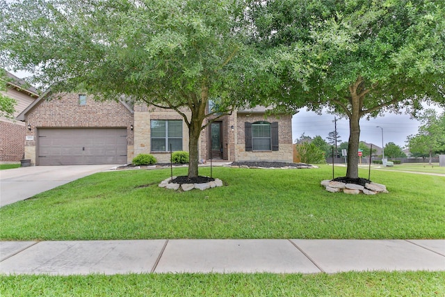 obstructed view of property featuring driveway, brick siding, a front yard, and a garage