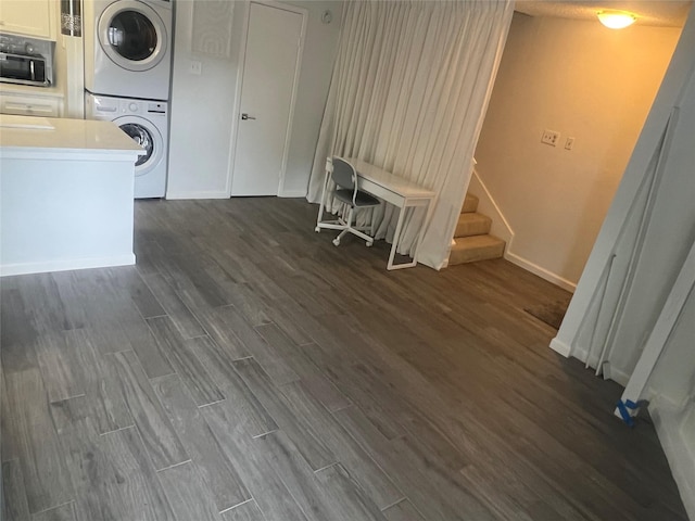 2800 Jeanetta St Unit 2104, Houston, TX 77063 - laundry room featuring dark wood-style floors, baseboards, stacked washer / dryer, and laundry area