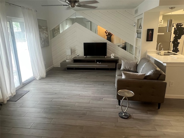 2800 Jeanetta St Unit 2104, Houston, TX 77063 - sitting room featuring a ceiling fan, wood finished floors, wooden walls, and visible vents