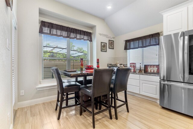 7407 Tudor Heights Ln, Spring, TX 77379 - dining area with vaulted ceiling, light wood-style flooring, and baseboards