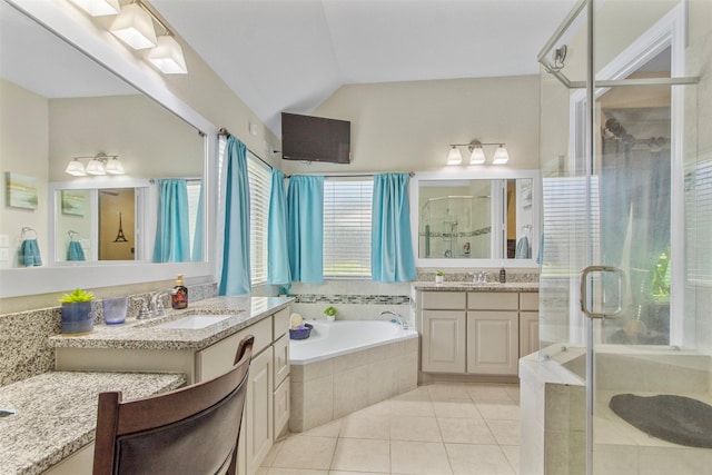 7407 Tudor Heights Ln, Spring, TX 77379 - bathroom featuring a stall shower, two vanities, a garden tub, tile patterned floors, and vaulted ceiling