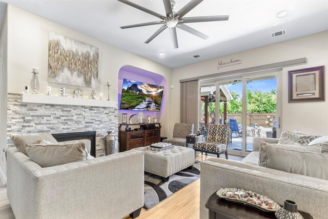 7407 Tudor Heights Ln, Spring, TX 77379 - living area featuring wood finished floors, a ceiling fan, a stone fireplace, and recessed lighting