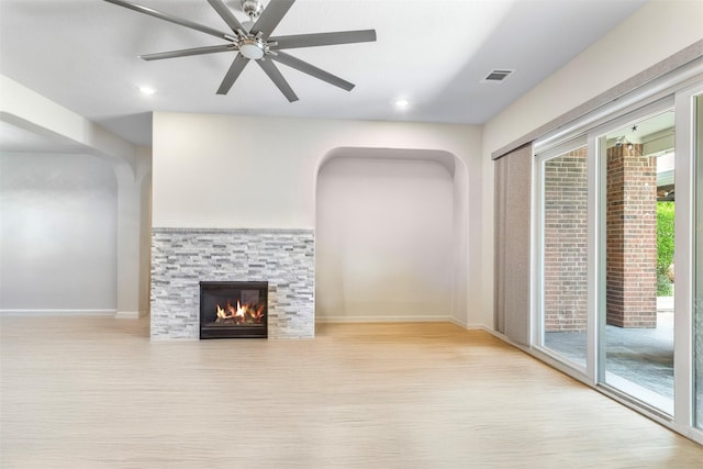 7407 Tudor Heights Ln, Spring, TX 77379 - unfurnished living room featuring baseboards, wood finished floors, a ceiling fan, a stone fireplace, and recessed lighting