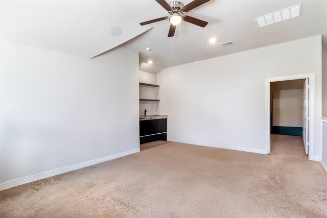 7407 Tudor Heights Ln, Spring, TX 77379 - unfurnished living room featuring light carpet, a sink, a ceiling fan, vaulted ceiling, and baseboards