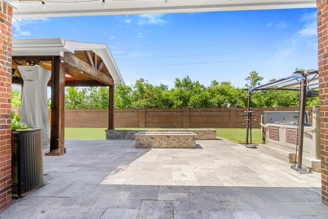7407 Tudor Heights Ln, Spring, TX 77379 - fenced backyard with area for grilling, a patio, and a fire pit