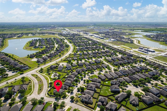drone / aerial view featuring a residential view and a water view