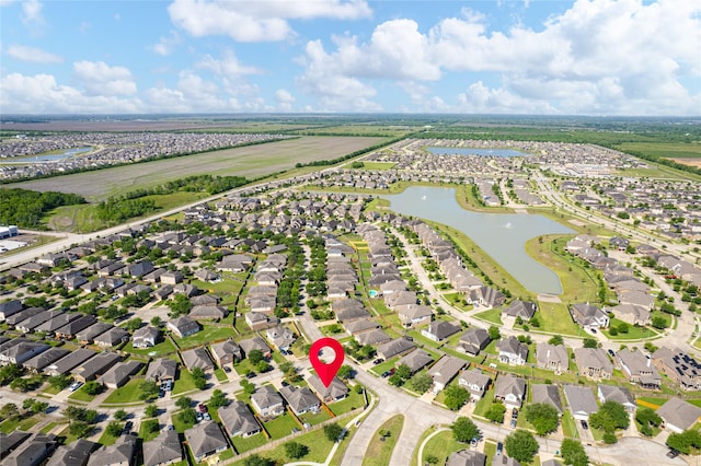 drone / aerial view featuring a residential view and a water view