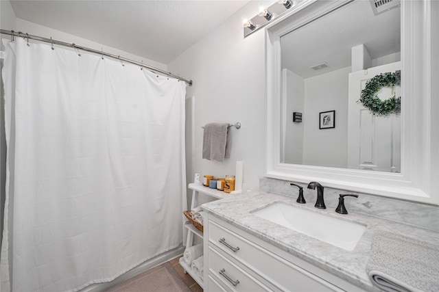 full bathroom featuring visible vents and vanity