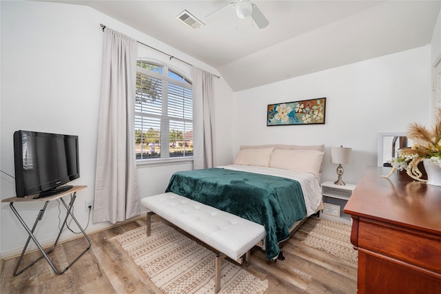 bedroom featuring wood finished floors, vaulted ceiling, visible vents, and ceiling fan