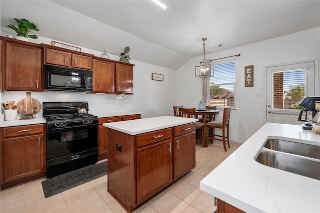 kitchen with a sink, black appliances, lofted ceiling, a notable chandelier, and a kitchen island