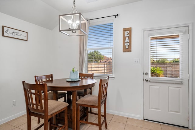 dining area featuring plenty of natural light, an inviting chandelier, and light tile patterned floors