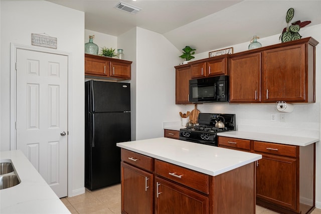 kitchen featuring light countertops, vaulted ceiling, visible vents, light tile patterned flooring, and black appliances