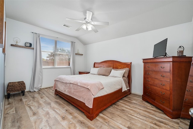 bedroom featuring vaulted ceiling, a ceiling fan, visible vents, and light wood-type flooring