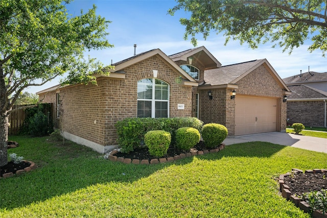 ranch-style house featuring roof with shingles, driveway, brick siding, a front yard, and a garage