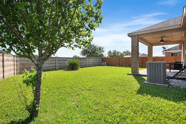 view of yard with central air condition unit, a patio area, a fenced backyard, and ceiling fan