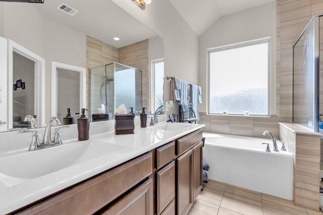 full bathroom featuring visible vents, a bath, a stall shower, and a sink
