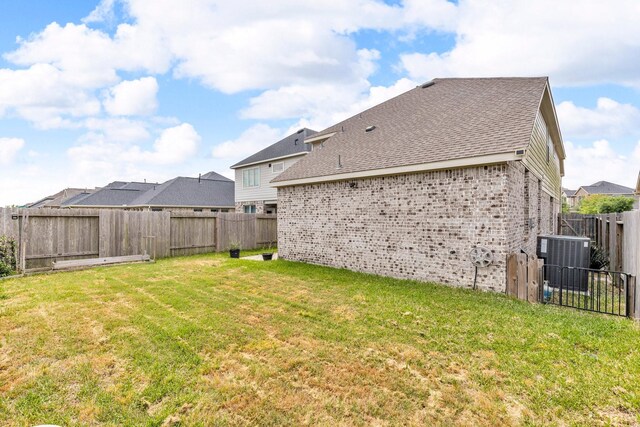 view of yard with cooling unit and a fenced backyard