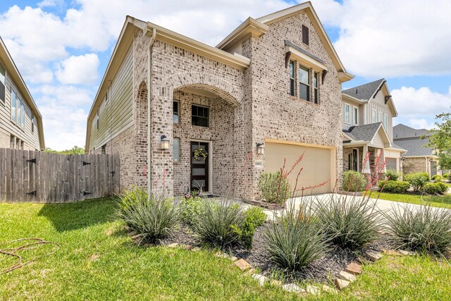 view of front of house featuring a front lawn, a garage, brick siding, concrete driveway, and fence
