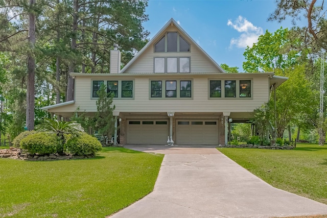 view of front of property featuring a garage, a chimney, a front lawn, and concrete driveway