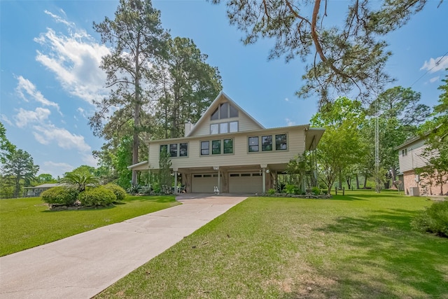 view of front of house with concrete driveway, a front lawn, and a garage